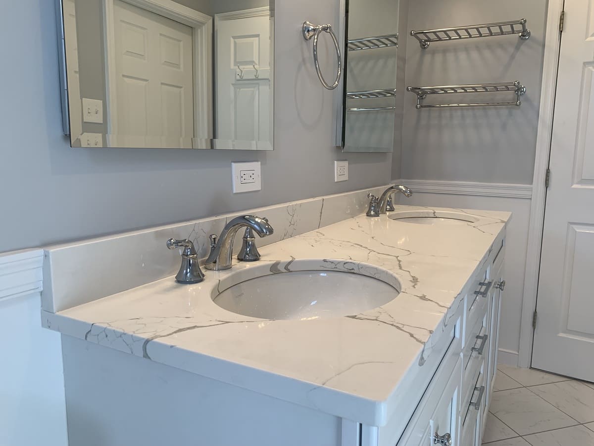 Bathroom remodel with double sink vanity and marble countertops