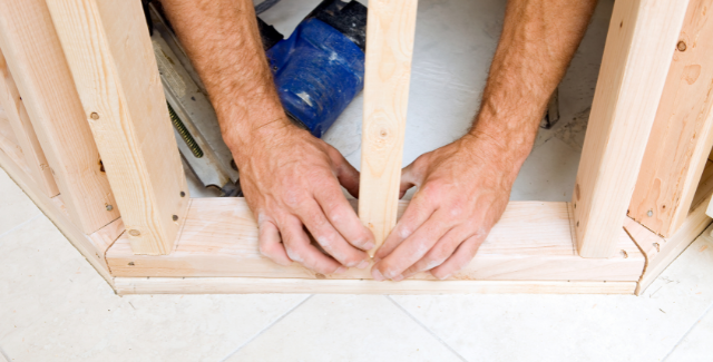 Two hands separating building zone from living space. 